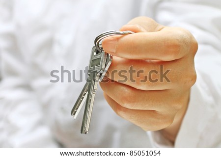 Woman\'s Hand offering house keys