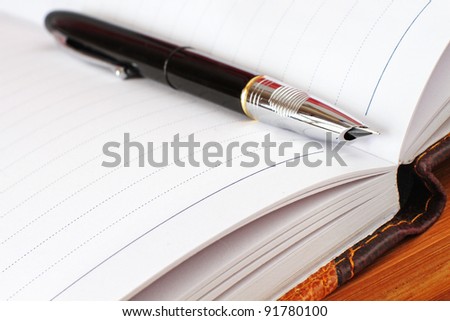 pen on an open Book