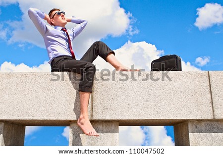 Satisfied with a guy on the roof is resting and basking in the sun