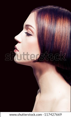 Brown Hair. Profile Beautiful Woman with stylish hairstyle on black background