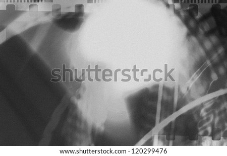 Grained black and white film strip abstract grunge texture with light effect