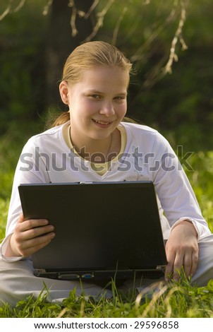 Girl in nature with laptop