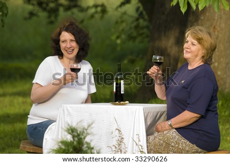 Mother and daughter, drinking wine