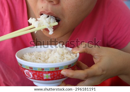 Closeup of woman eating rice