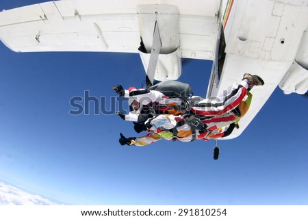A man is not afraid to jump on a plane , launching in the clouds. Skydiving.