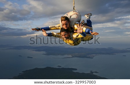 Sky diving tandem over the beach and coast