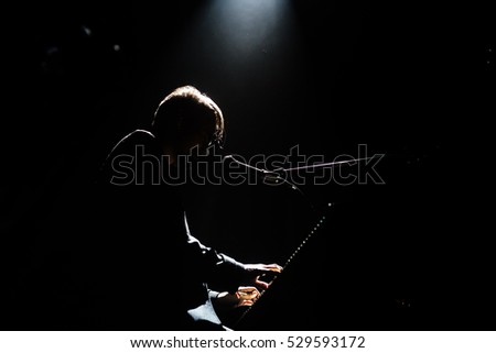 Silhouette of pianist in dark