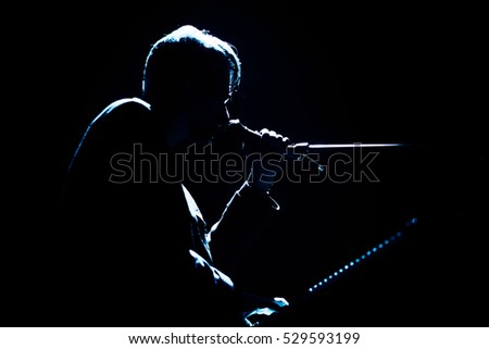 Silhouette of singer with piano