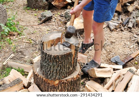 Man chopping wood in the backyard