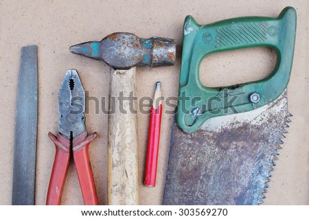 The old tool for work of the carpenter. The tool for work on a backyard.