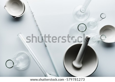 Flasks and vessels of a chemical laboratory. Table with equipment lab. Top view from head.