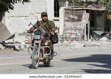 SYRIA, DAMASCUS - SEPTEMBER 2013. A soldier of the Syrian National Army patrol area on the outskirts of Damascus.
