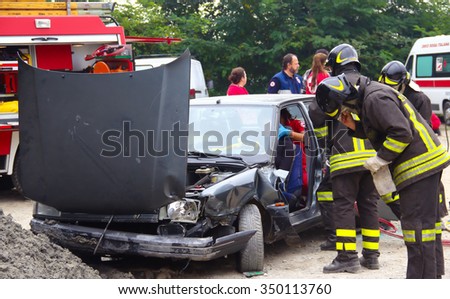 Rescue simulation of accident. Val Della Torre, Italy - September, 28 2014: Simulation of road accidents, joint intervention between firefighters and rescuers.