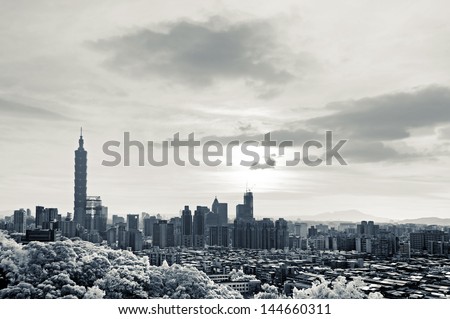 Cityscape with 101 skyscraper under dramatic clouds, infrared photography in Taipei, Taiwan, Asia.