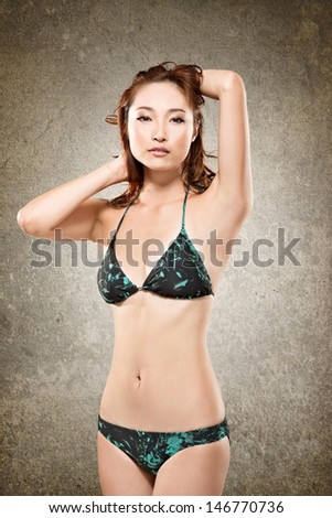 Attractive Asian lady in bikini, closeup portrait.
