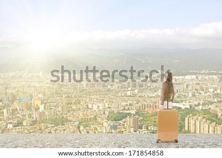 Modern Asian woman stand with a luggage in the roof of high building in the city.