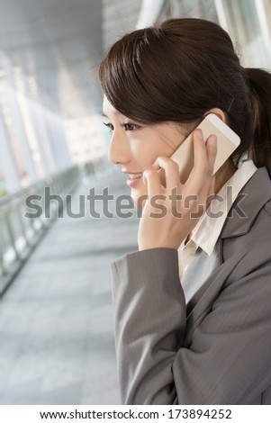 Young business woman use cellphone, closeup portrait.