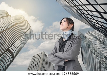 Confident Asian business woman stand and think, closeup portrait with office building background.