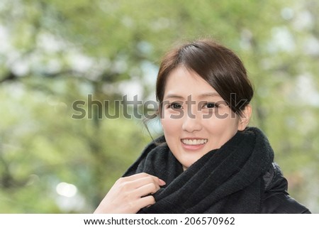 Attractive young woman in the city of winter sunny sprinkling rain days.