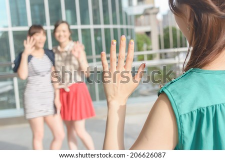 Asian woman meet her friends in the outside.