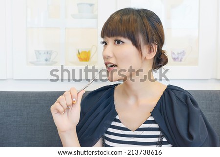 Asian woman eat lunch with funny face.
