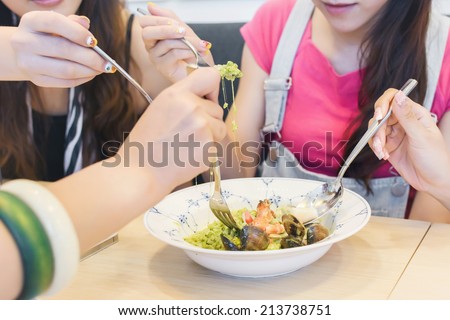 Asian woman share her lunch in the restaurant.