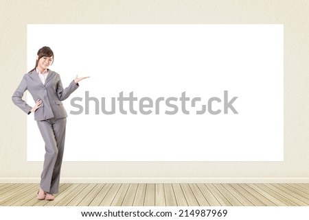 Asian business young woman introduce with blank board in a room.