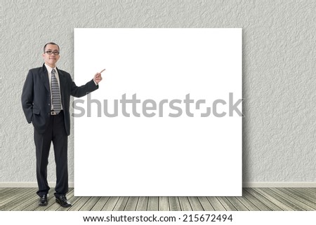 Asian business man introduce with blank board in a room.