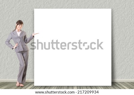 Asian business young woman introduce with blank board in a room.