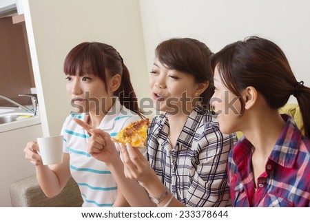 Asian women chat, close-up indoor portrait.