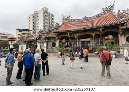 TAIPEI, TAIWAN - November 16th : Tourists and believers in the square of Longshan Temple, Taiwan on November 16th, 2014.