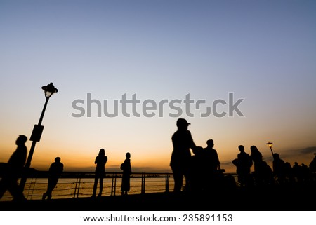 Sunset scenery with silhouette of people walk at Tamsui old street at Tamsui, New Taipei City, Taiwan.