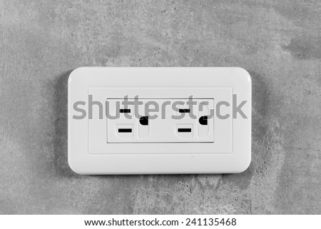 Socket, electrical outlet on gray wall. Close-up image.
