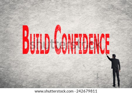 Asian business man write words on wall, Build Confidence