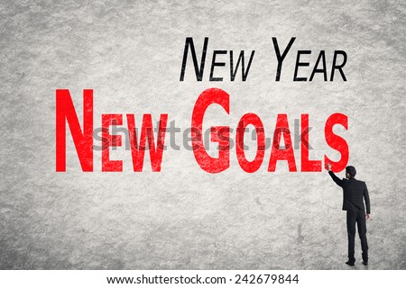 Asian business man write words on wall, New Year New Goals
