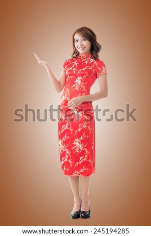 Chinese woman dress traditional cheongsam at New Year and introducing, full length portrait isolated.