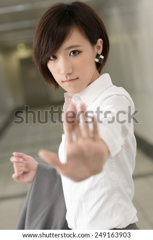 Young business woman give you a NO gesture, closeup portrait.