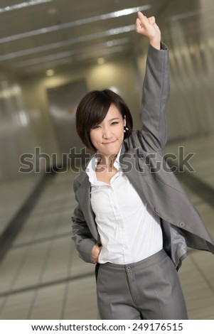 Cheerful and exciting business woman of Asian inside of modern buildings.