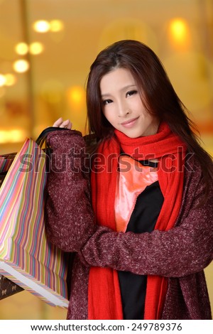 Asian shopping woman holding bags.