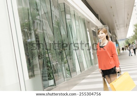 Smile young woman shopping at street in Xinyi district, the business and commercial center in Taipei, Taiwan, Asia.
