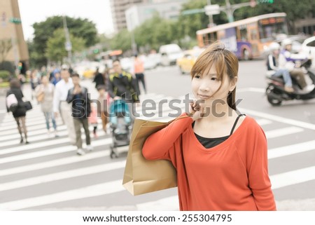 Smile young woman shopping at street in Xinyi district, the business and commercial center in Taipei, Taiwan, Asia.