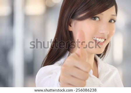 Asian businesswoman gesture with thumb up on white background.