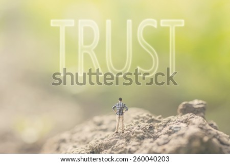 Concept of faith with a person stand in the outdoor and looking up the text over the sky in nature background.