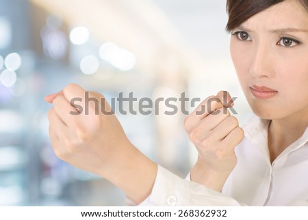 Businesswoman fight pose with confident expression on white background.