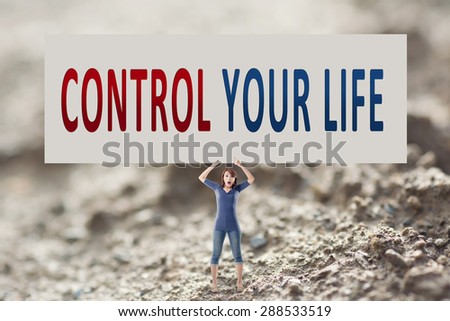 Control your life, words on blank board hold by a young girl in the outdoor.