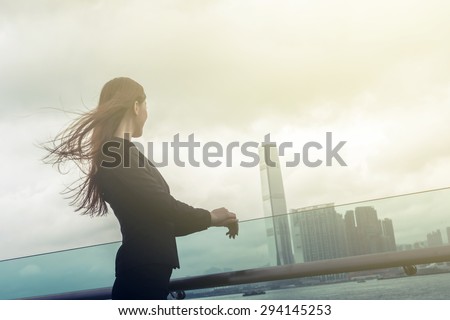 Silhouette of businesswoman stand and look far away in Hong Kong, Asia.