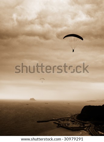 It is a kind of sport called parachuting over the sea.