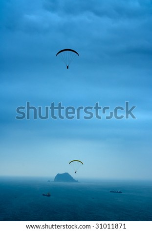 It is a kind of sport called parachuting over the sea.