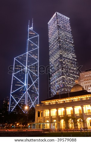 It is night scene of two skyscrapers behind a English building in Hong Kong.