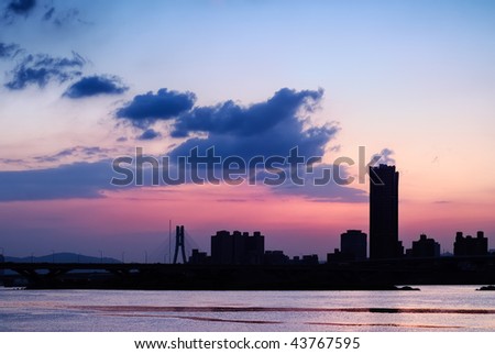 Silhouette  cityscape with beautiful sunset background and architecture beyond river in Taipei, Taiwan.